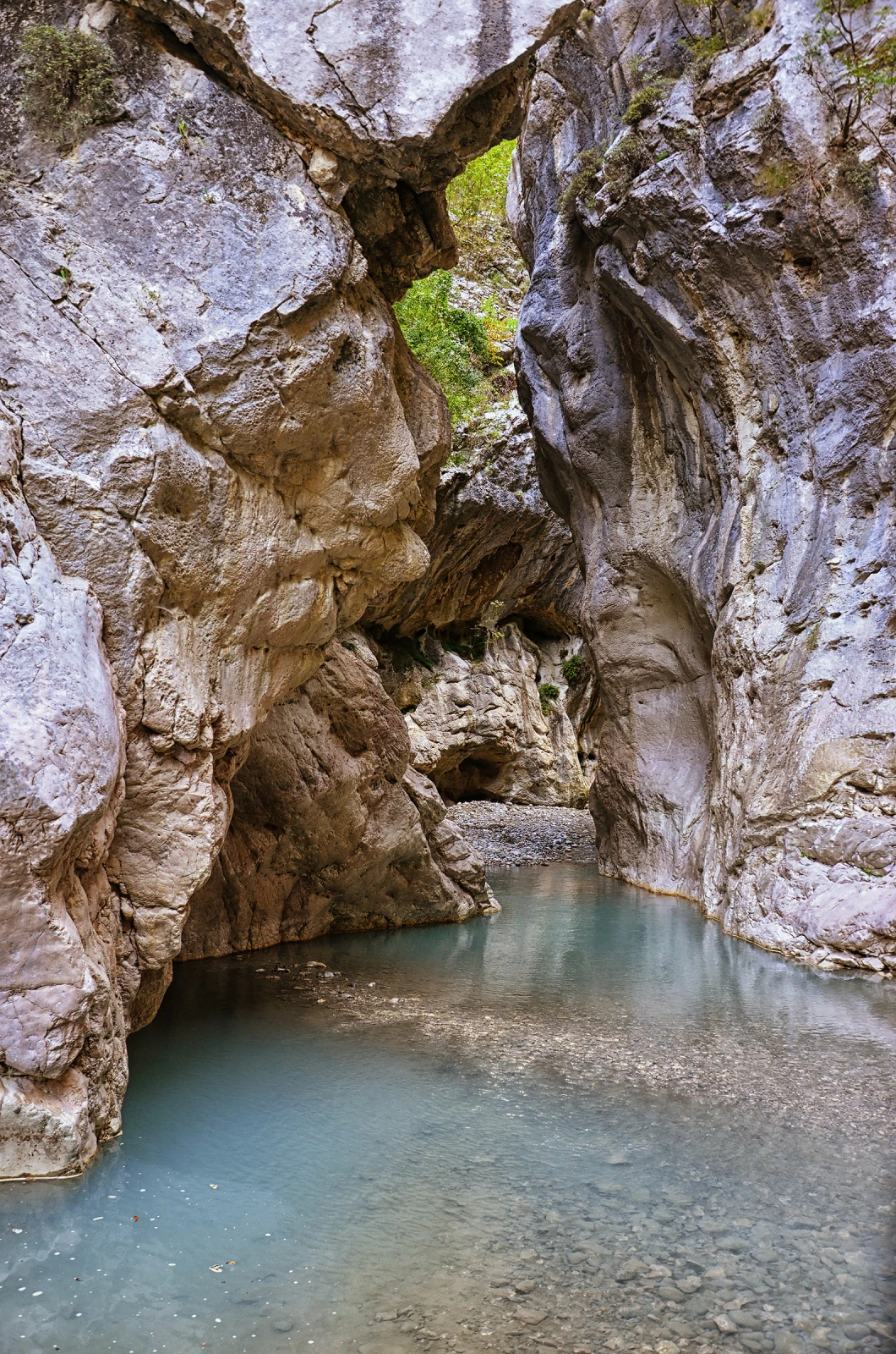 Clear water running through the narrow limestone walls of Hölte Canyon near Gramsh.