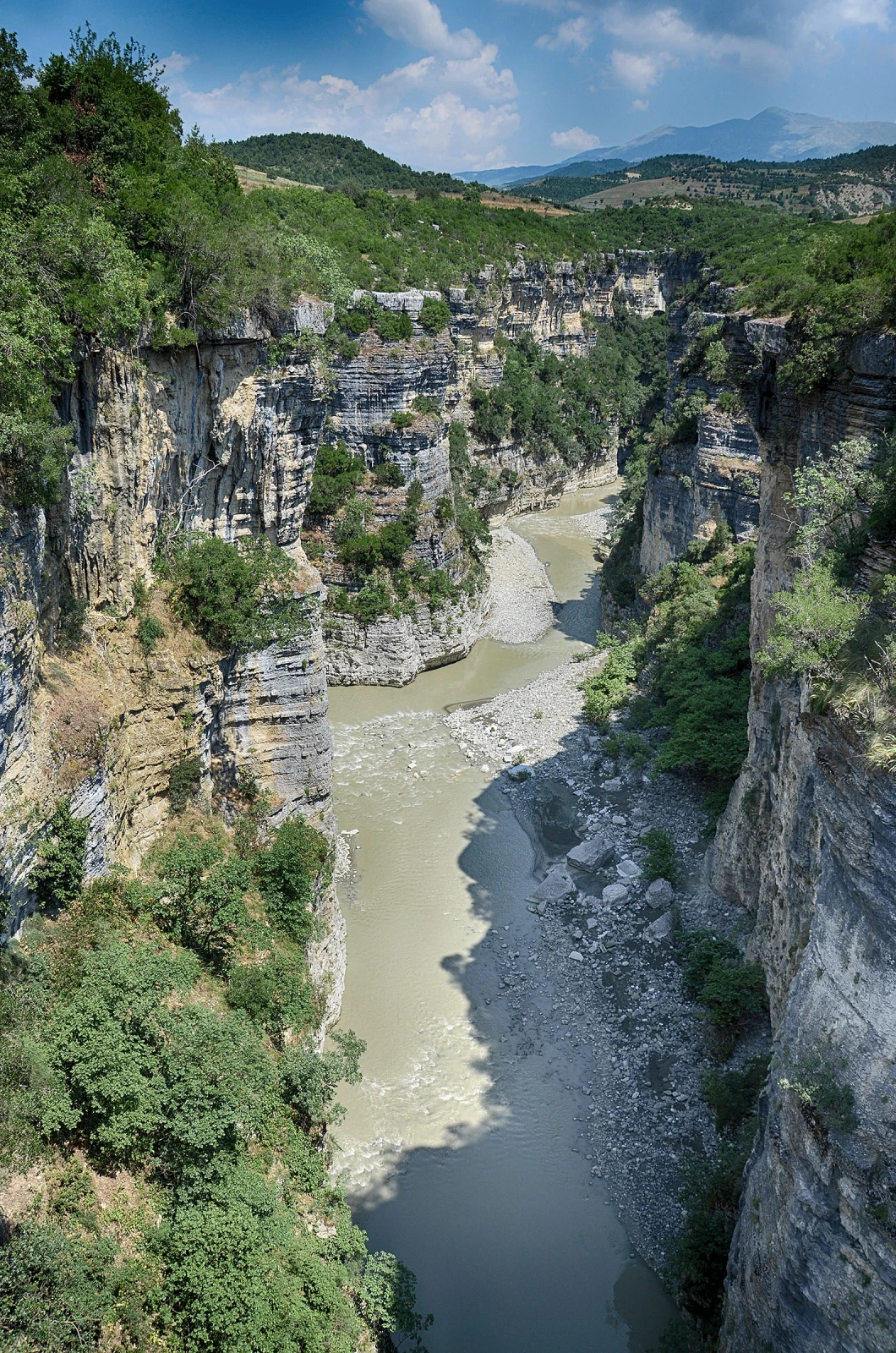 The Osum River passing between tall limestone walls in Osum Canyon.