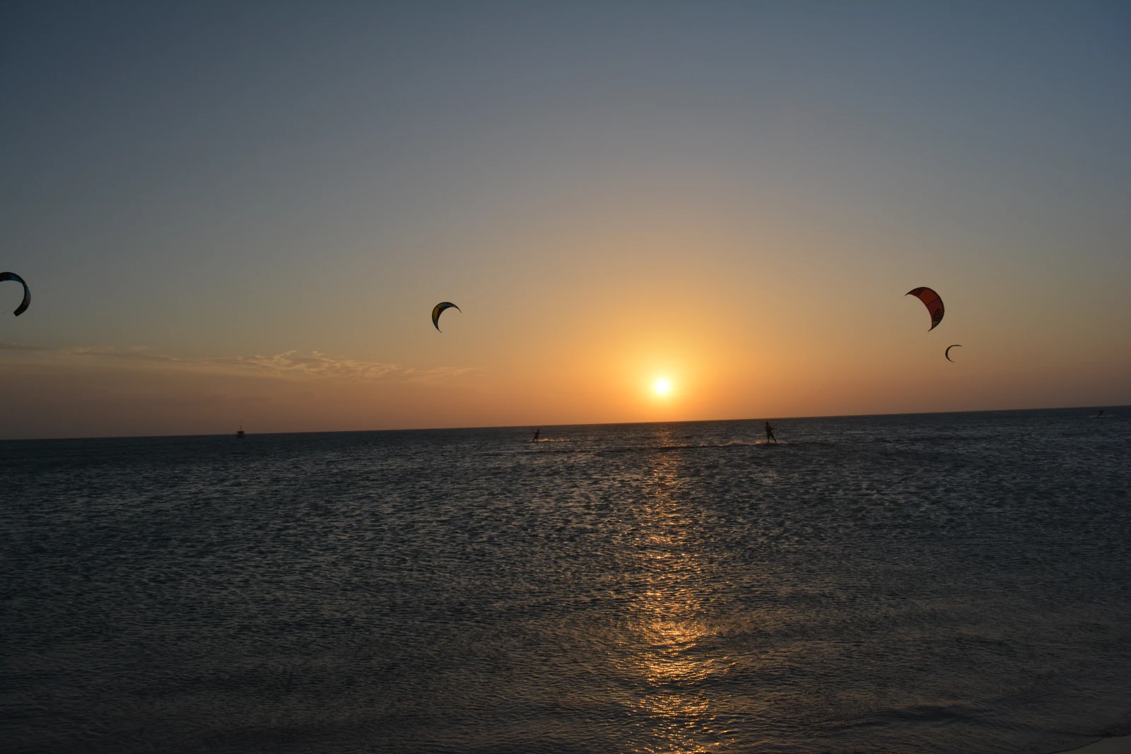 Kitesurfers crossing the sea at sunset near Cabo de la Vela, Colombia.
