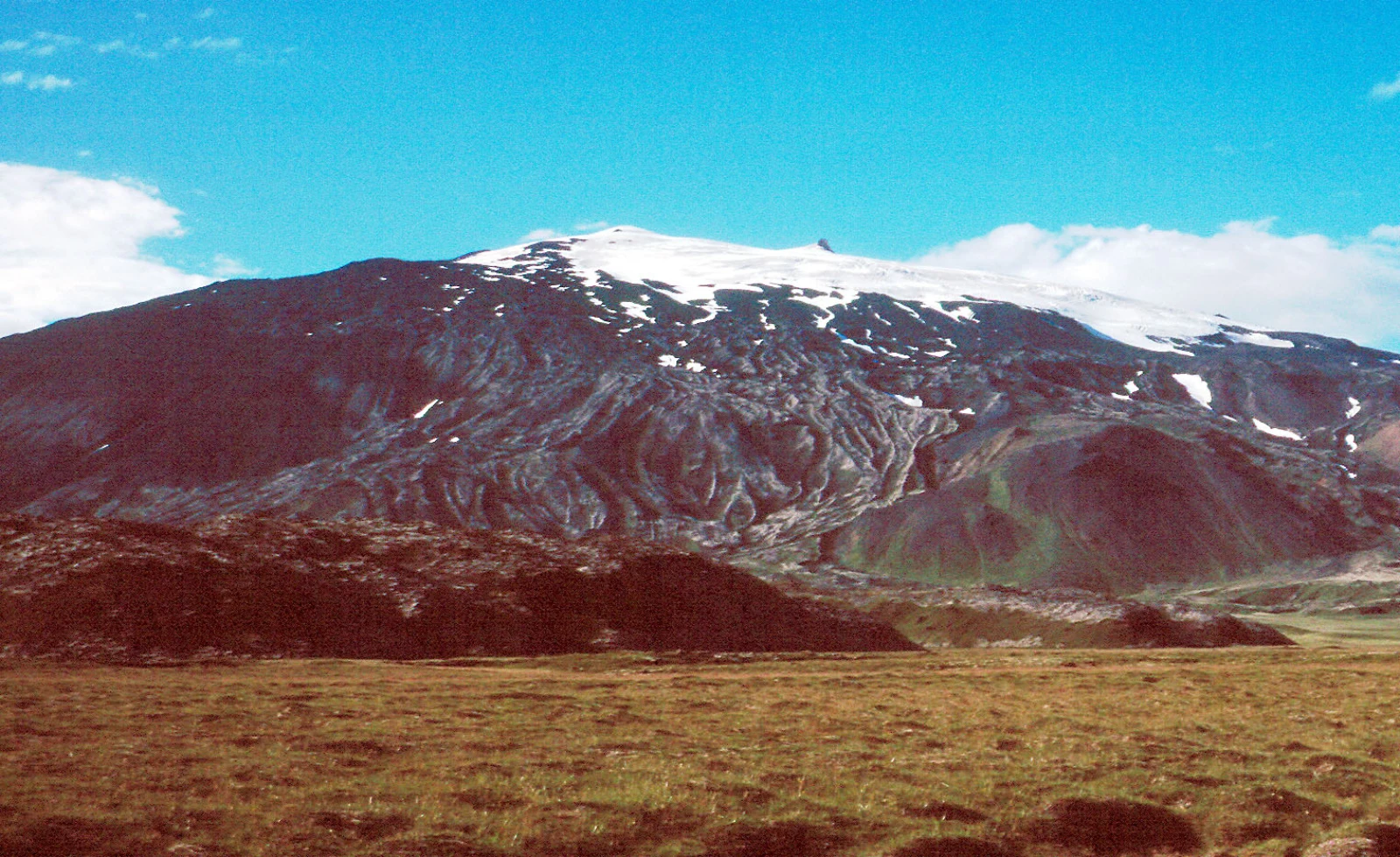 Iceland's glacier-capped Snæfellsjökull volcano above the surrounding peninsula.