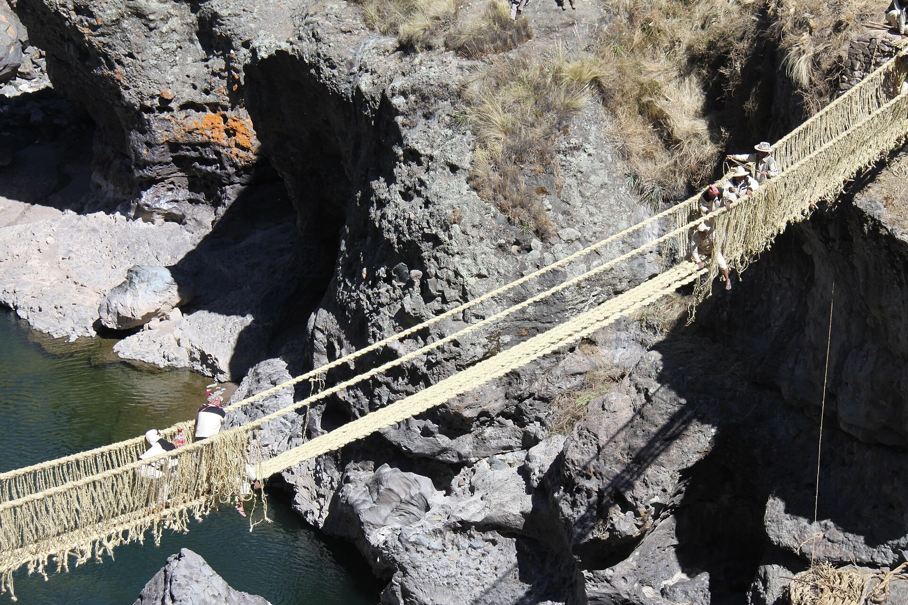 The woven Q'eswachaka bridge spanning its canyon in Peru.