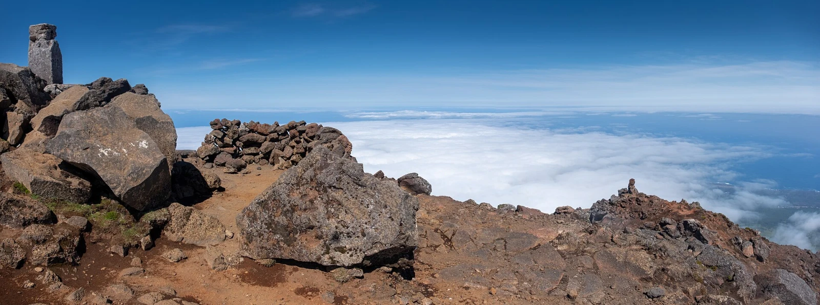 Hikers at the summit of Mount Pico above the Azorean cloud layer.