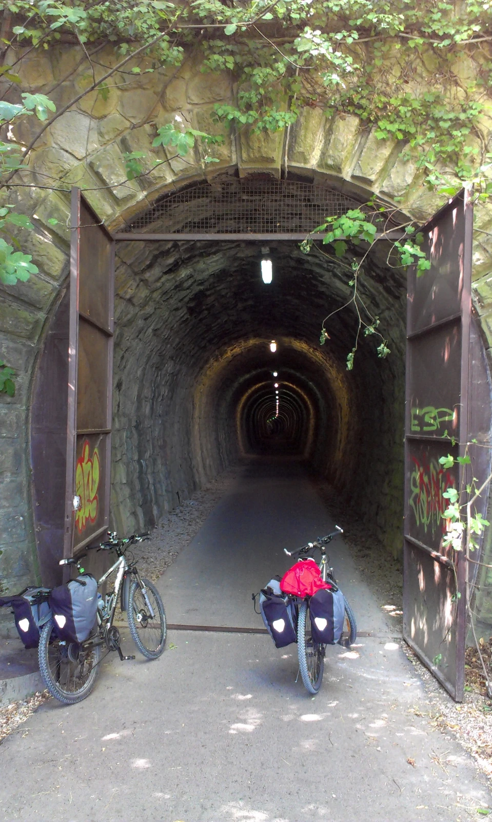 Cyclists entering a former railway tunnel on the Parenzana.