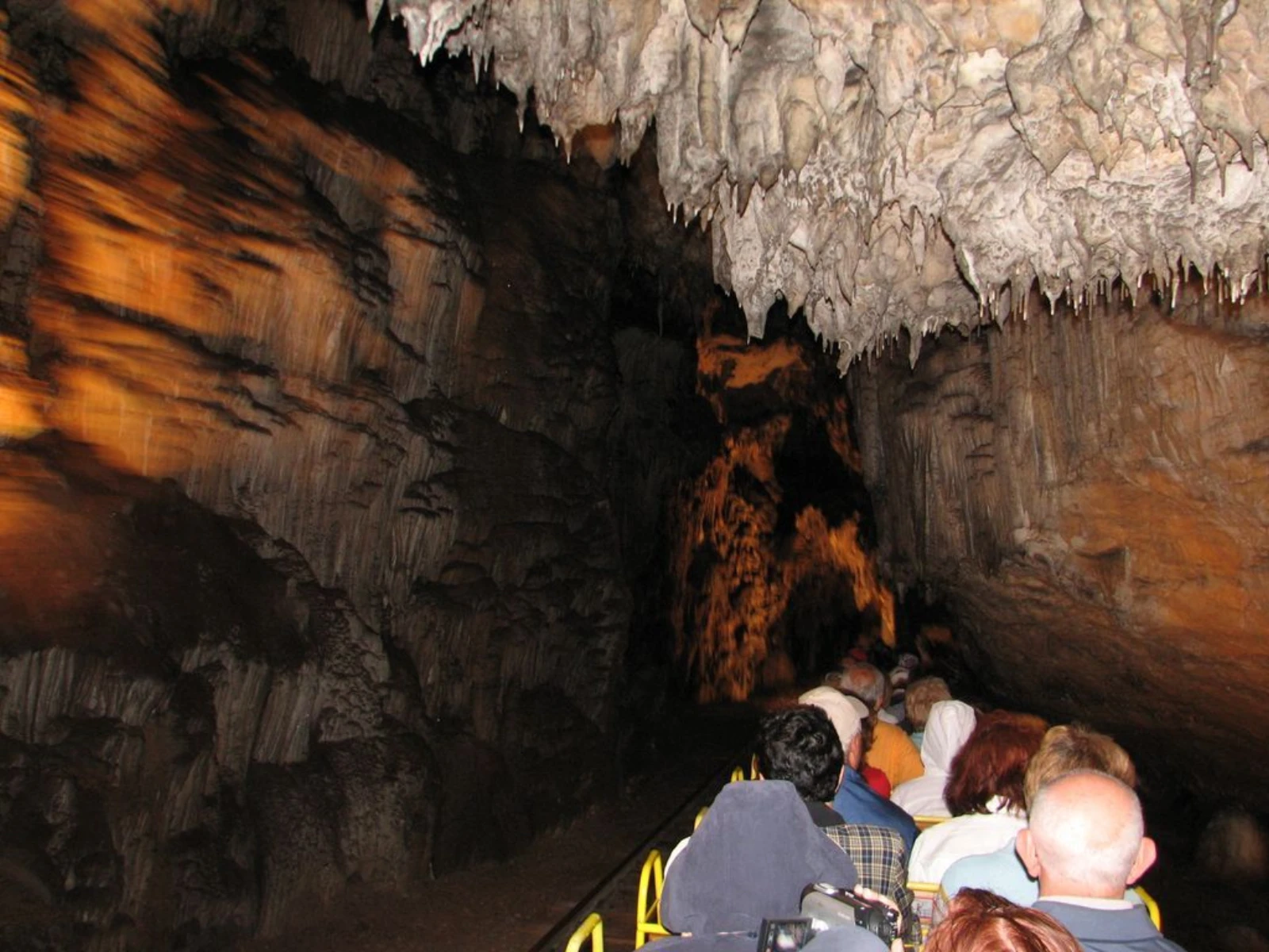 Visitors riding the underground train through Postojna Cave.