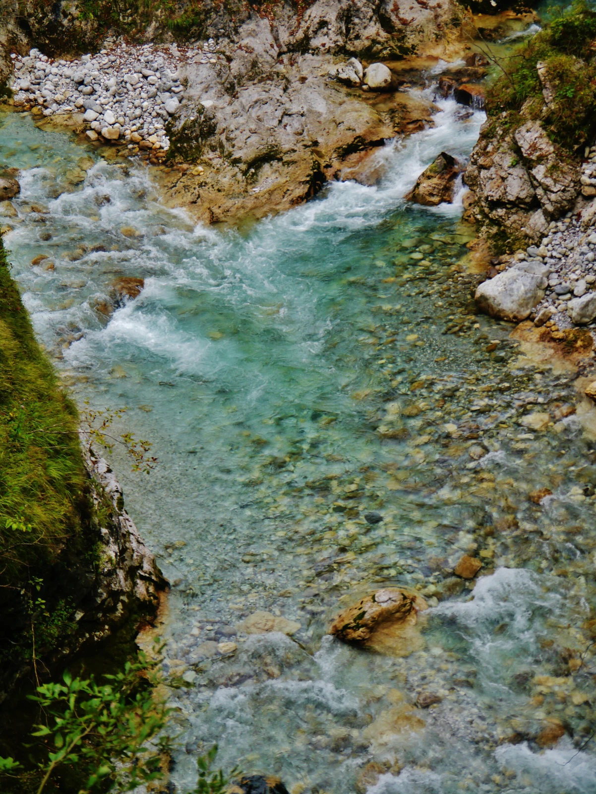 Clear rushing water in the limestone walls of Tolmin Gorges.