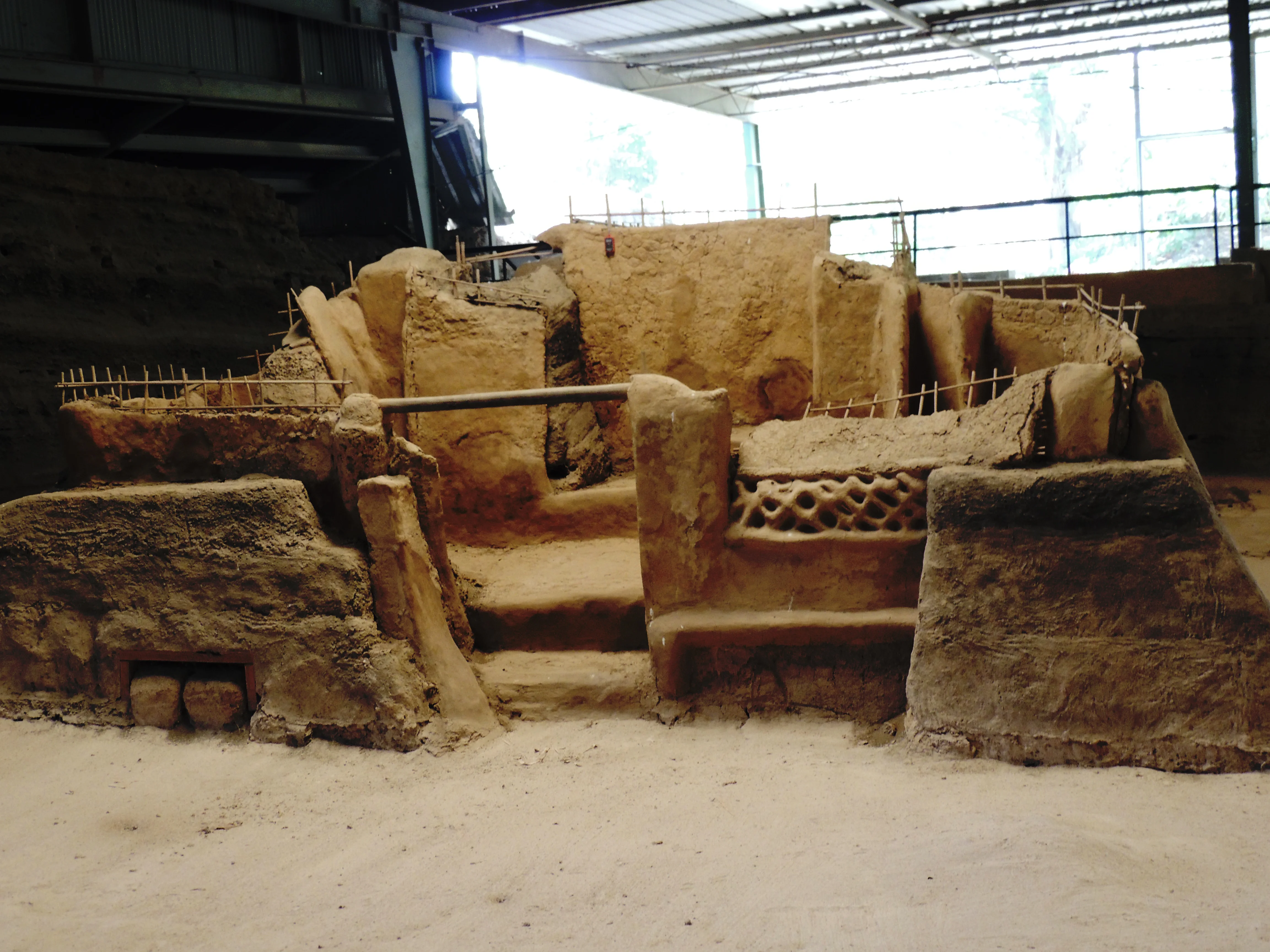 Preserved earthen household structures beneath a protective roof at Joya de Cerén in El Salvador.