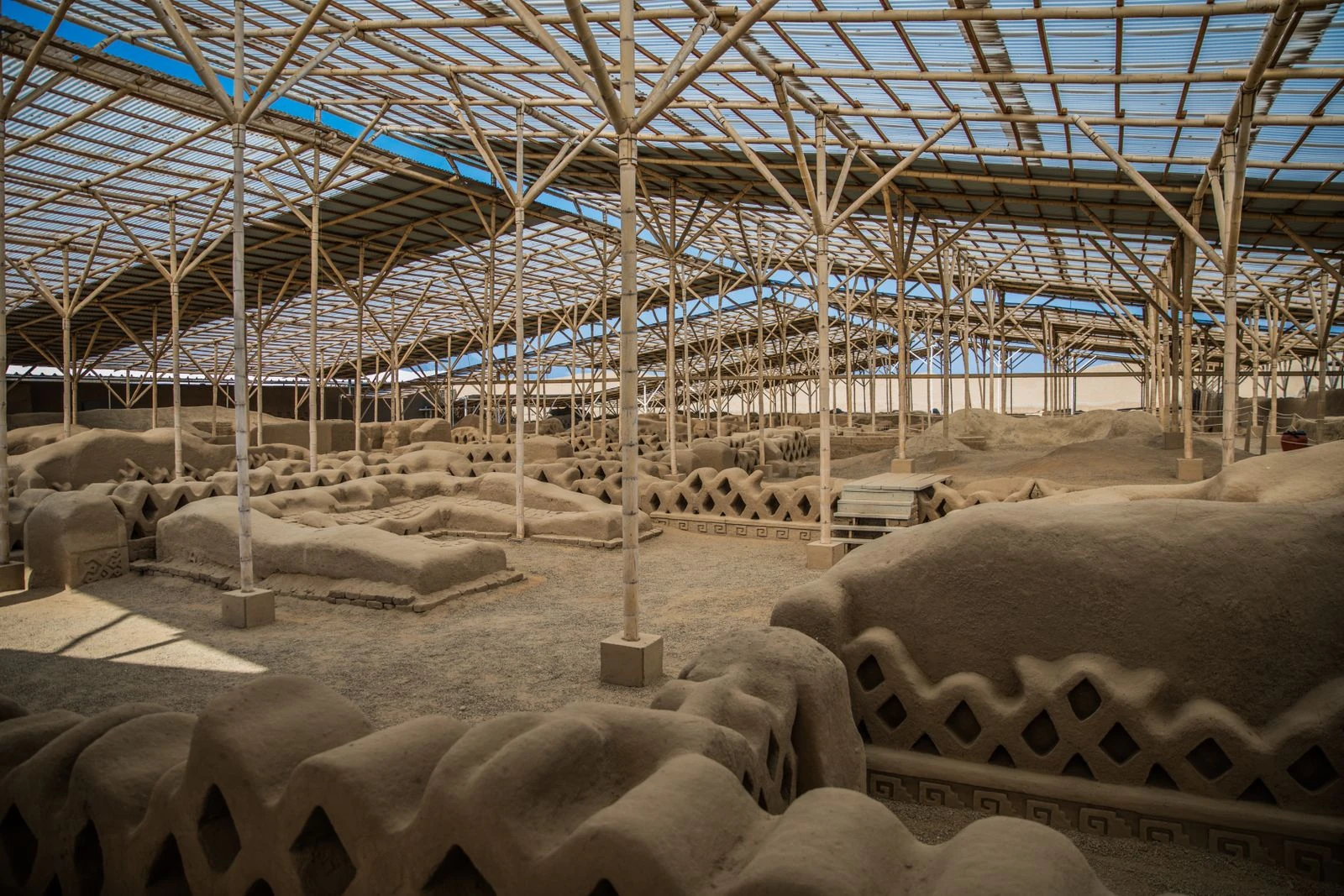 Geometric adobe walls receding through the protected city of Chan Chan.
