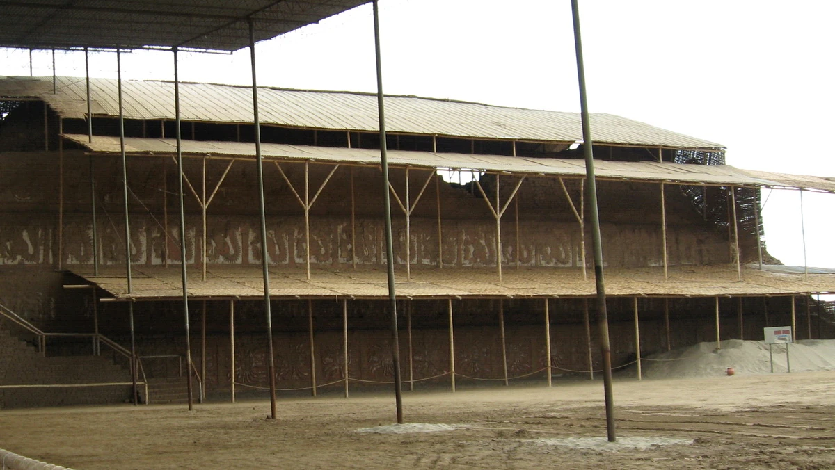 Colored geometric and figurative reliefs on a wall at Huaca de la Luna.
