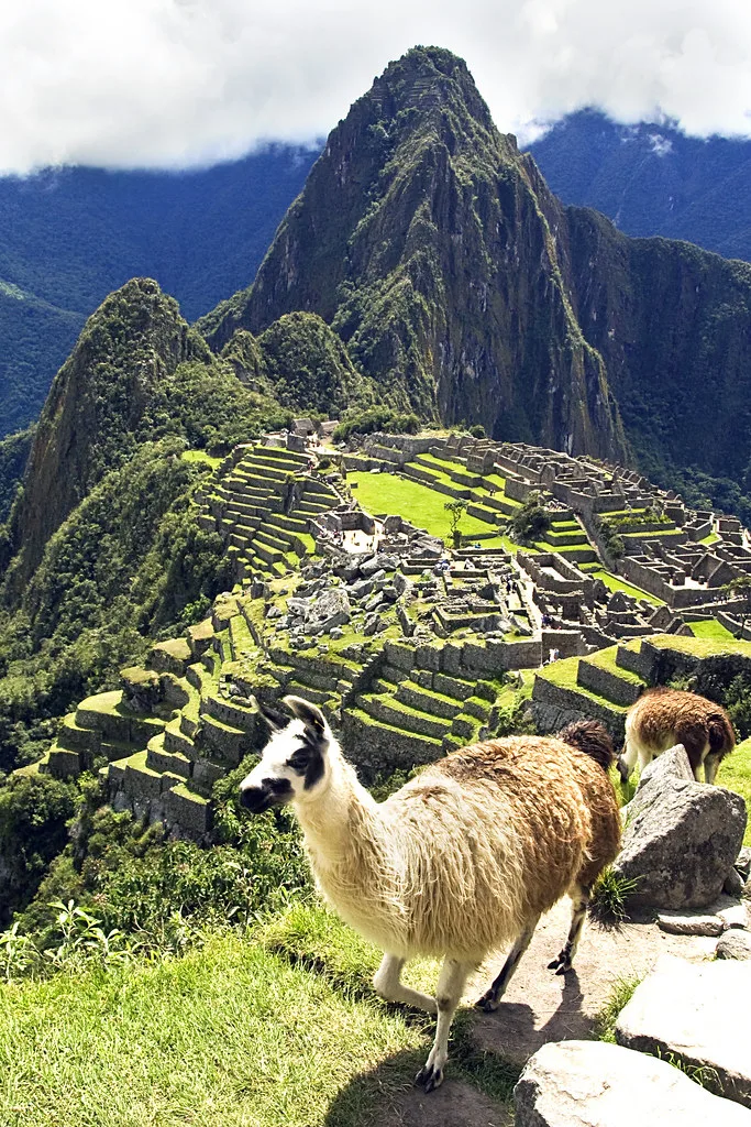 Machu Picchu and Huayna Picchu beneath clouds.