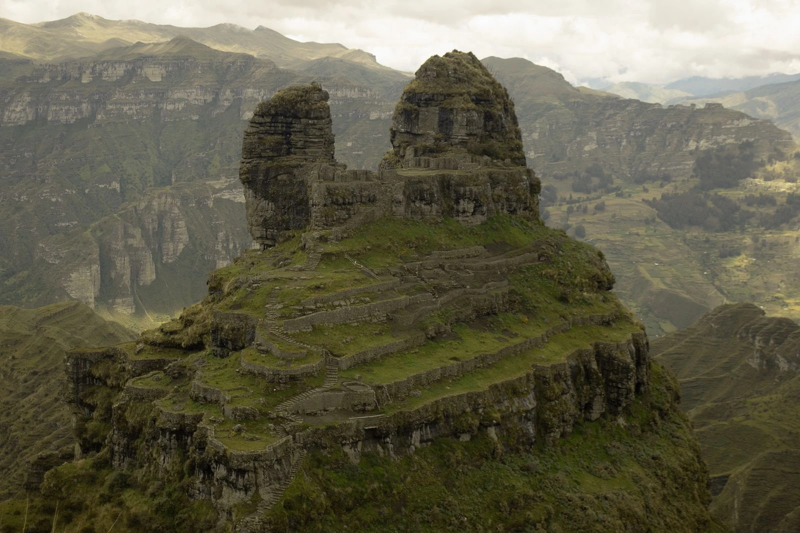 Waqrapukara's twin stone horns rising above the deep Apurímac canyon.