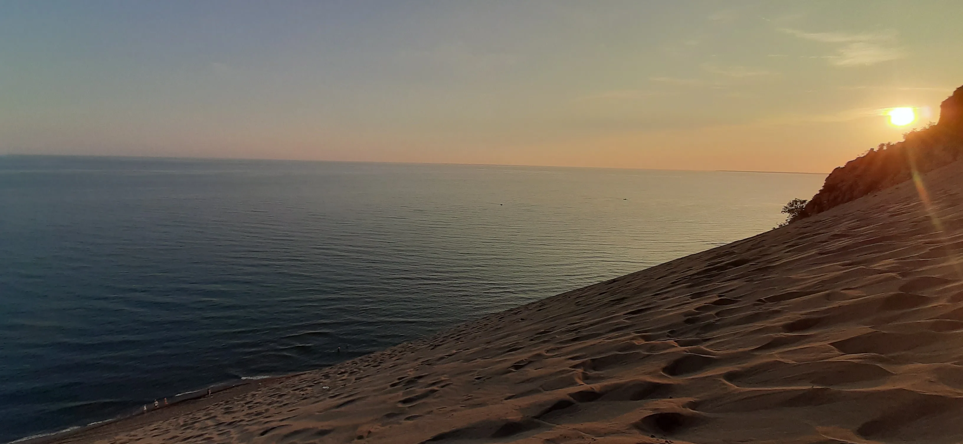 The steep sand slope of Rana e Hedhun descending to the Adriatic at sunset.