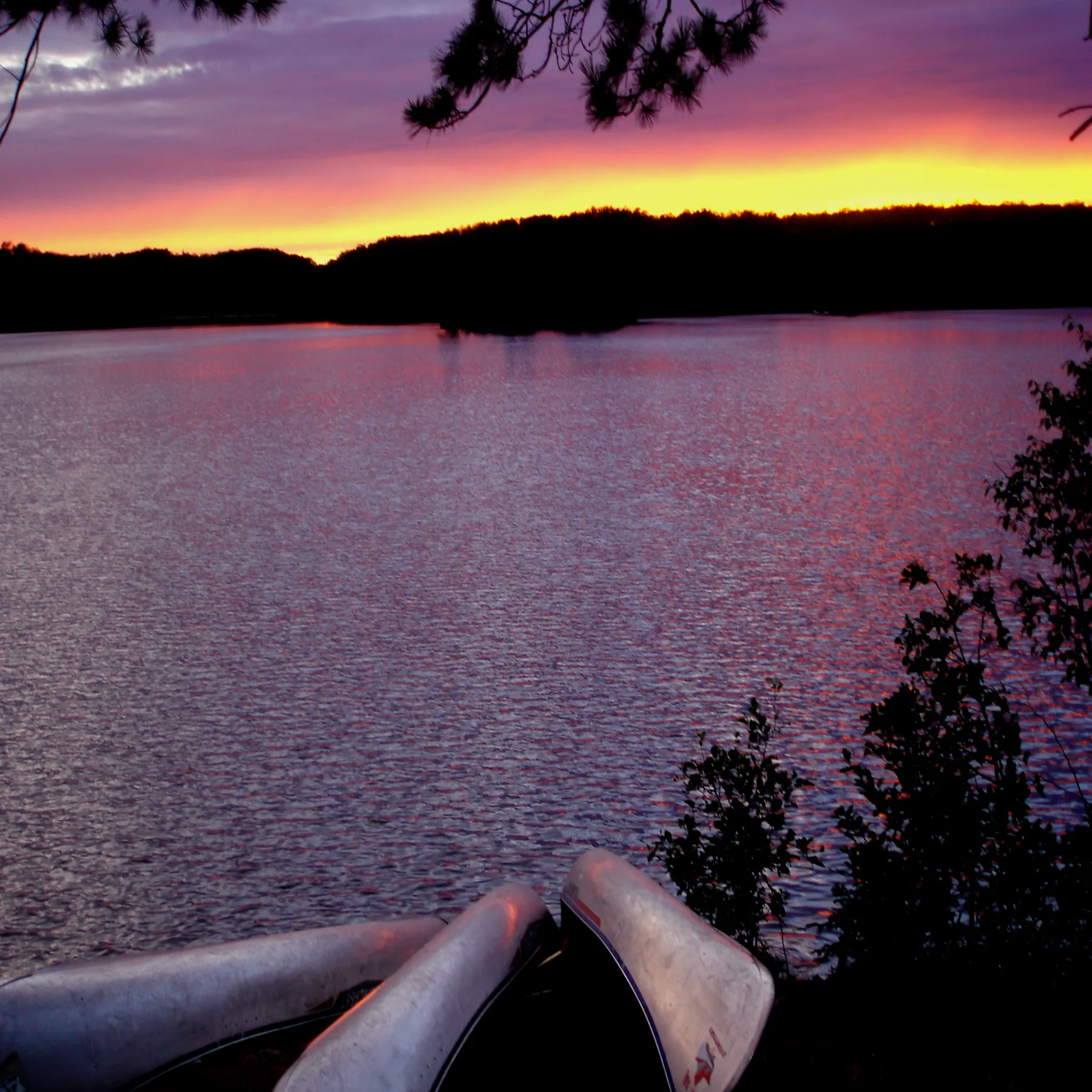 Canoes on a lake at sunset in Quetico Provincial Park.