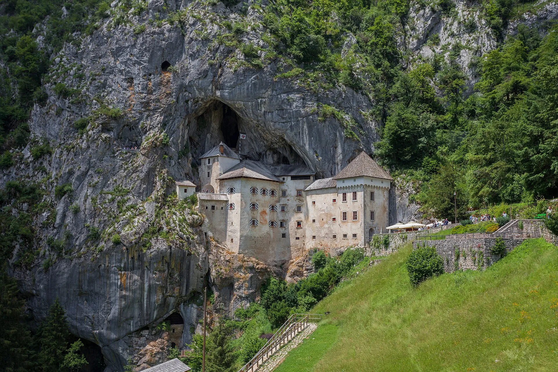 Predjama Castle built dramatically into the entrance of a limestone cliff cave.