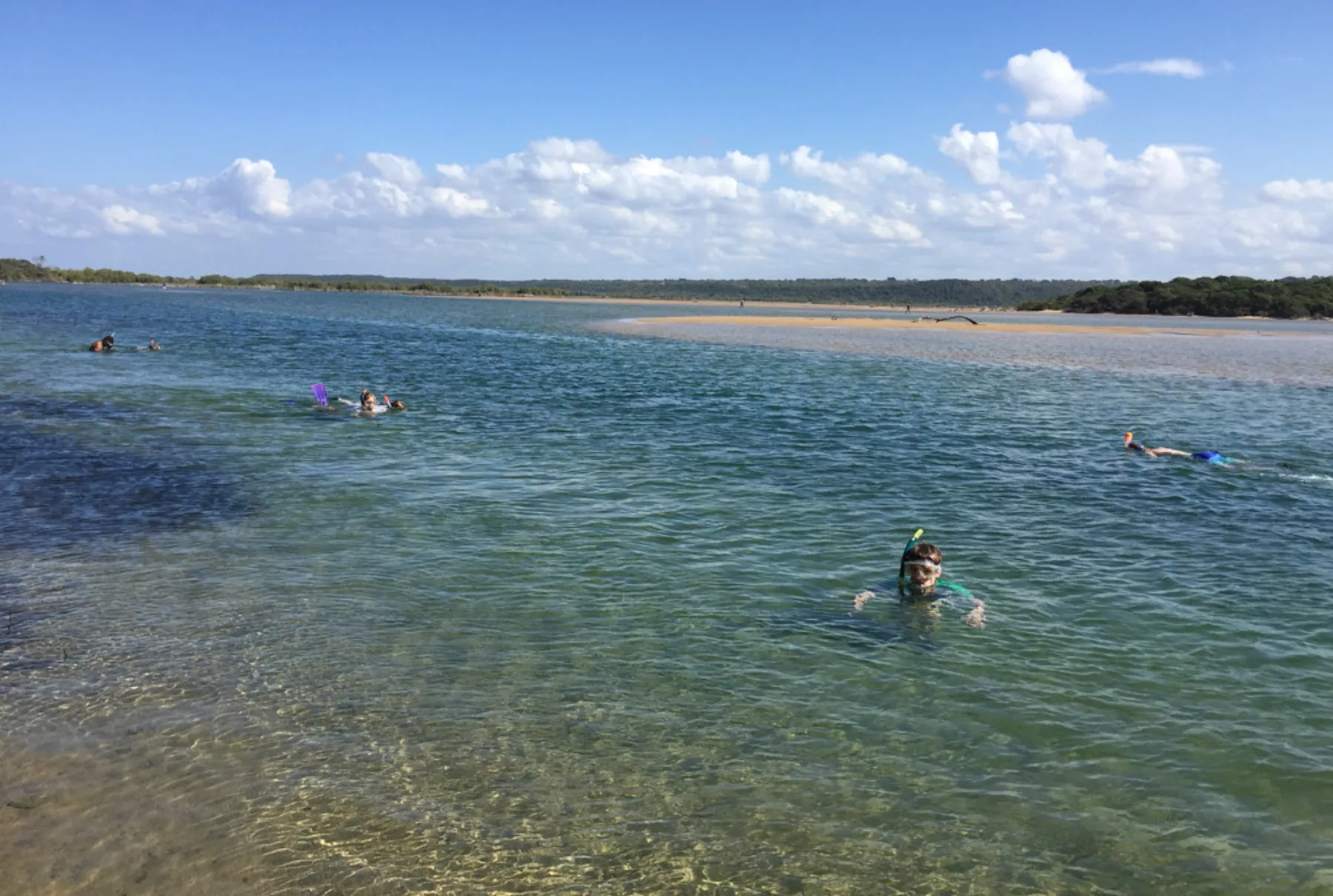 People snorkel in the clear water at Kosi Bay Mouth, South Africa.