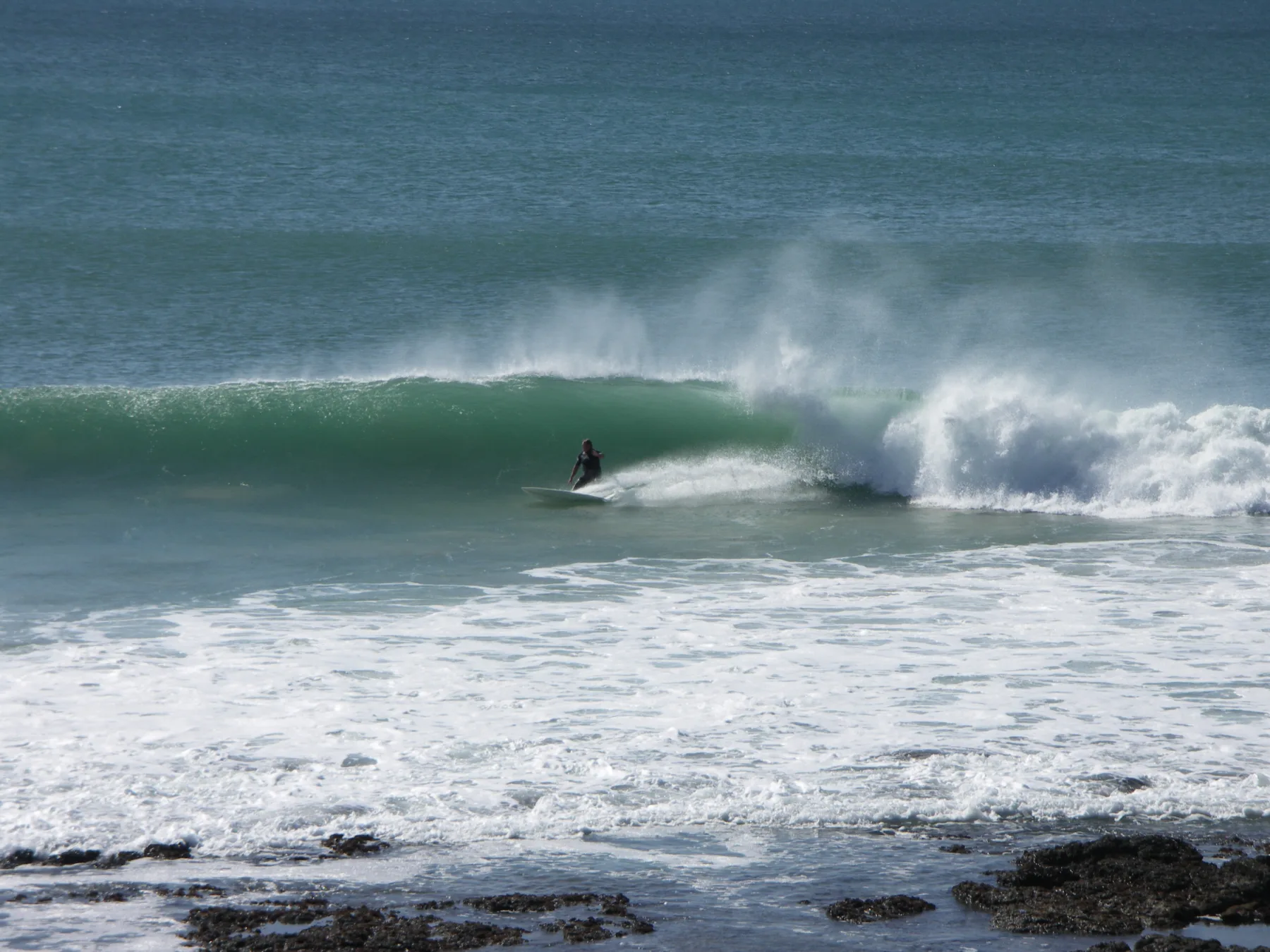 A surfer rides a breaking wave at Supertubes in Jeffreys Bay, South Africa.