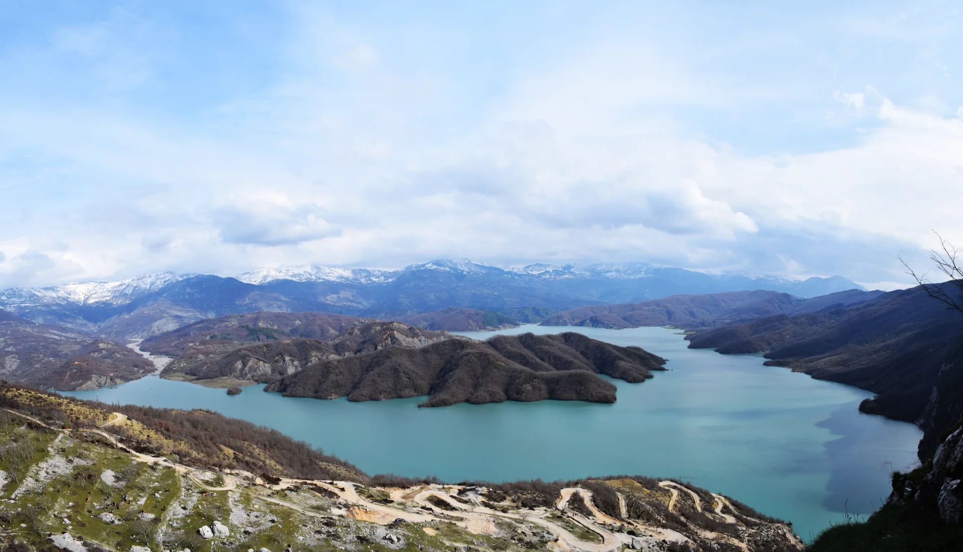 Lake Bovilla reservoir viewed from the high limestone slopes of Gamti Mountain.