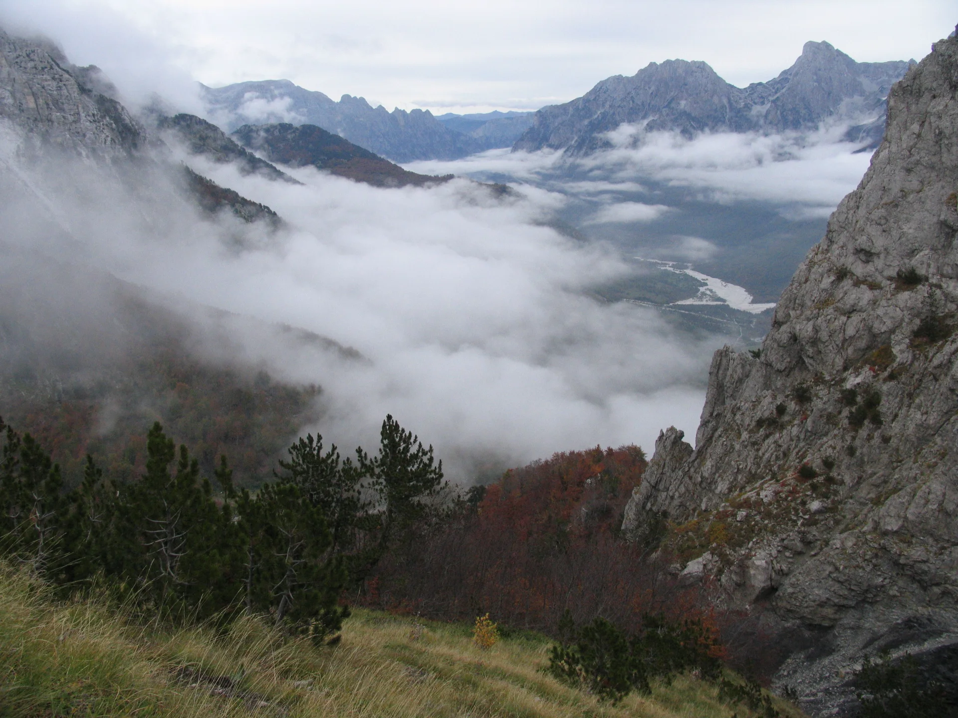 Rocky slopes and low cloud above the Valbona Pass in the Albanian Alps.