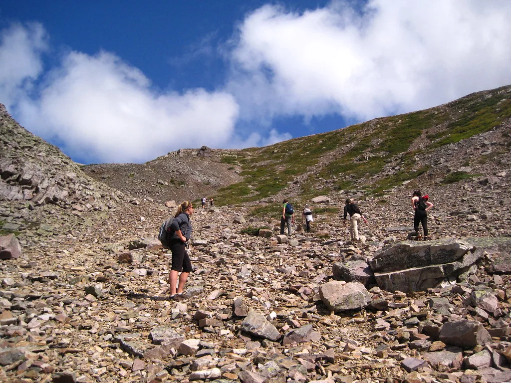Hikers climbing Gros Morne Mountain.