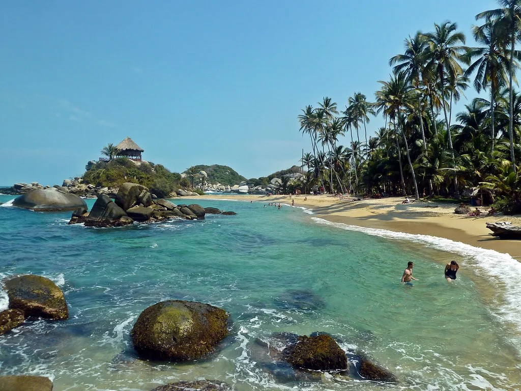 Palm-lined beach and granite boulders at Cabo San Juan in Tayrona National Park.
