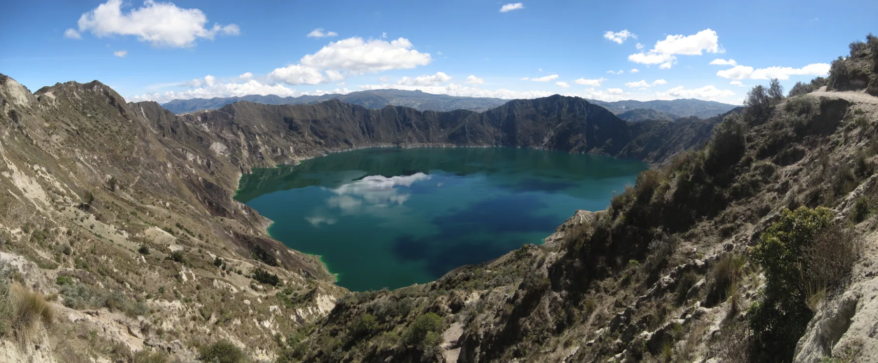The turquoise Quilotoa crater lake enclosed by its steep volcanic rim.