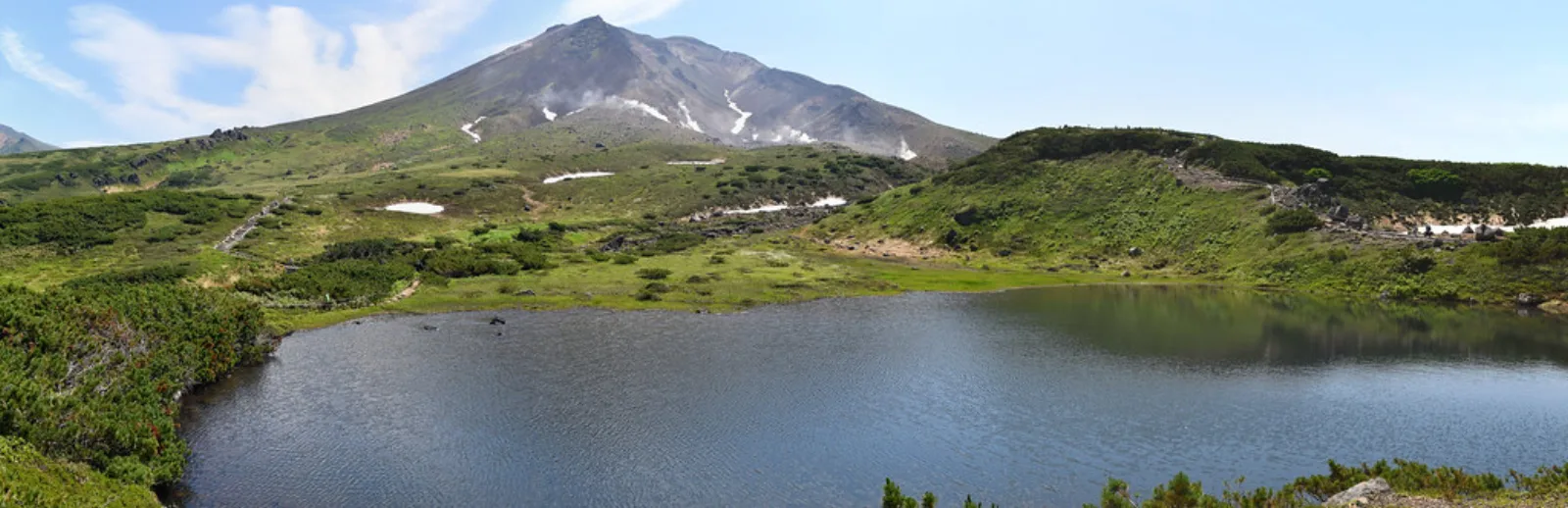 Mount Asahidake rises behind alpine ponds and tundra.