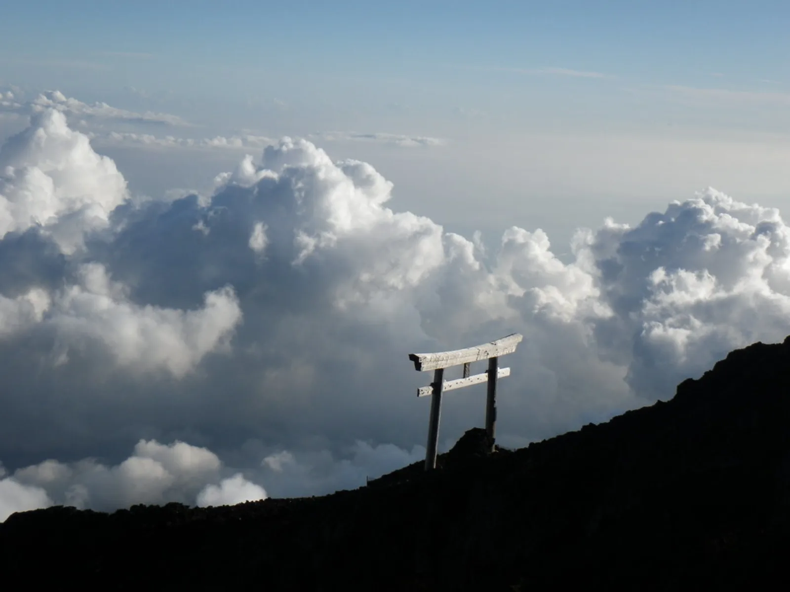 A torii gate marks the summit trail on Mount Fuji.