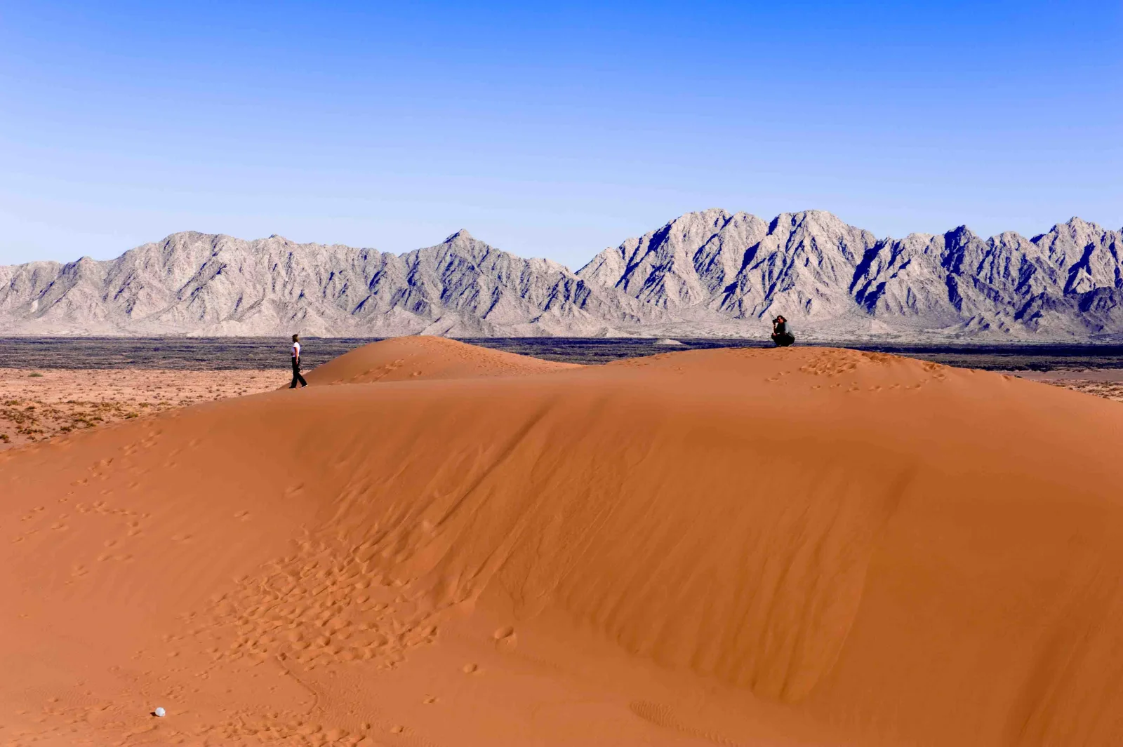 A red sand dune and mountain range in the Gran Desierto de Altar region.