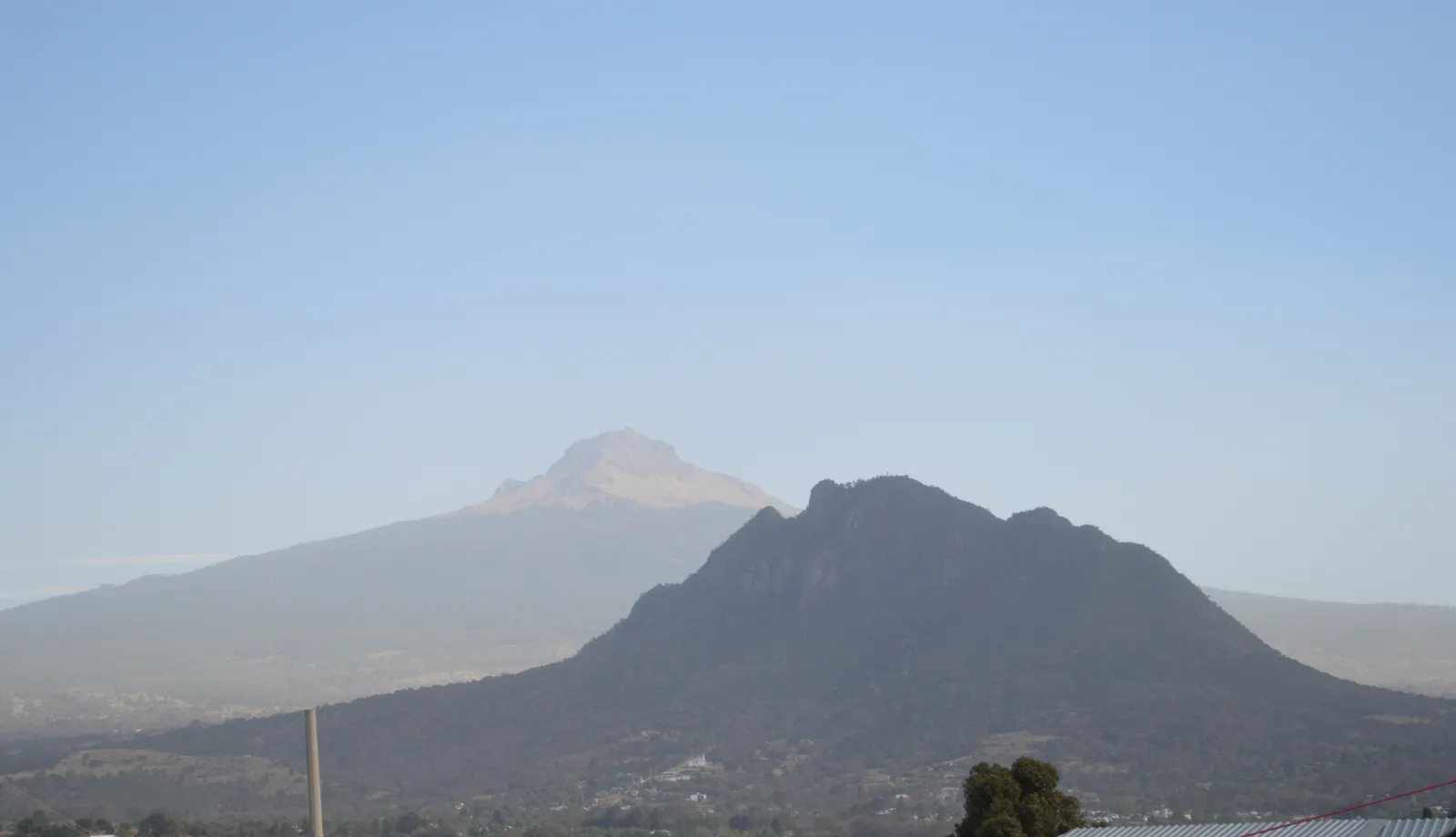 La Malinche volcano rises beyond the forested foreground in Tlaxcala.