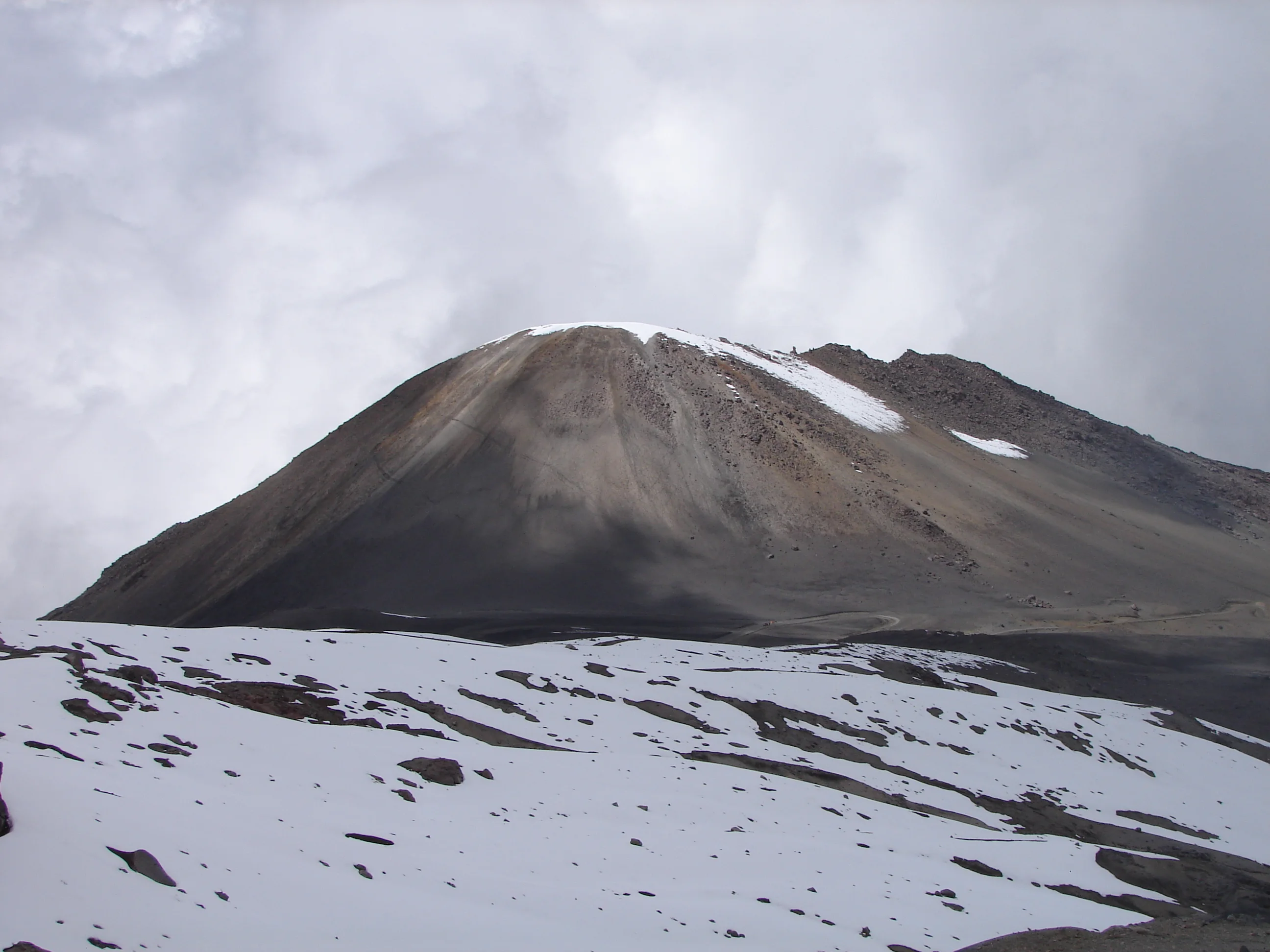 Snow-streaked volcanic terrain at Cráter de la Olleta in Los Nevados National Natural Park.