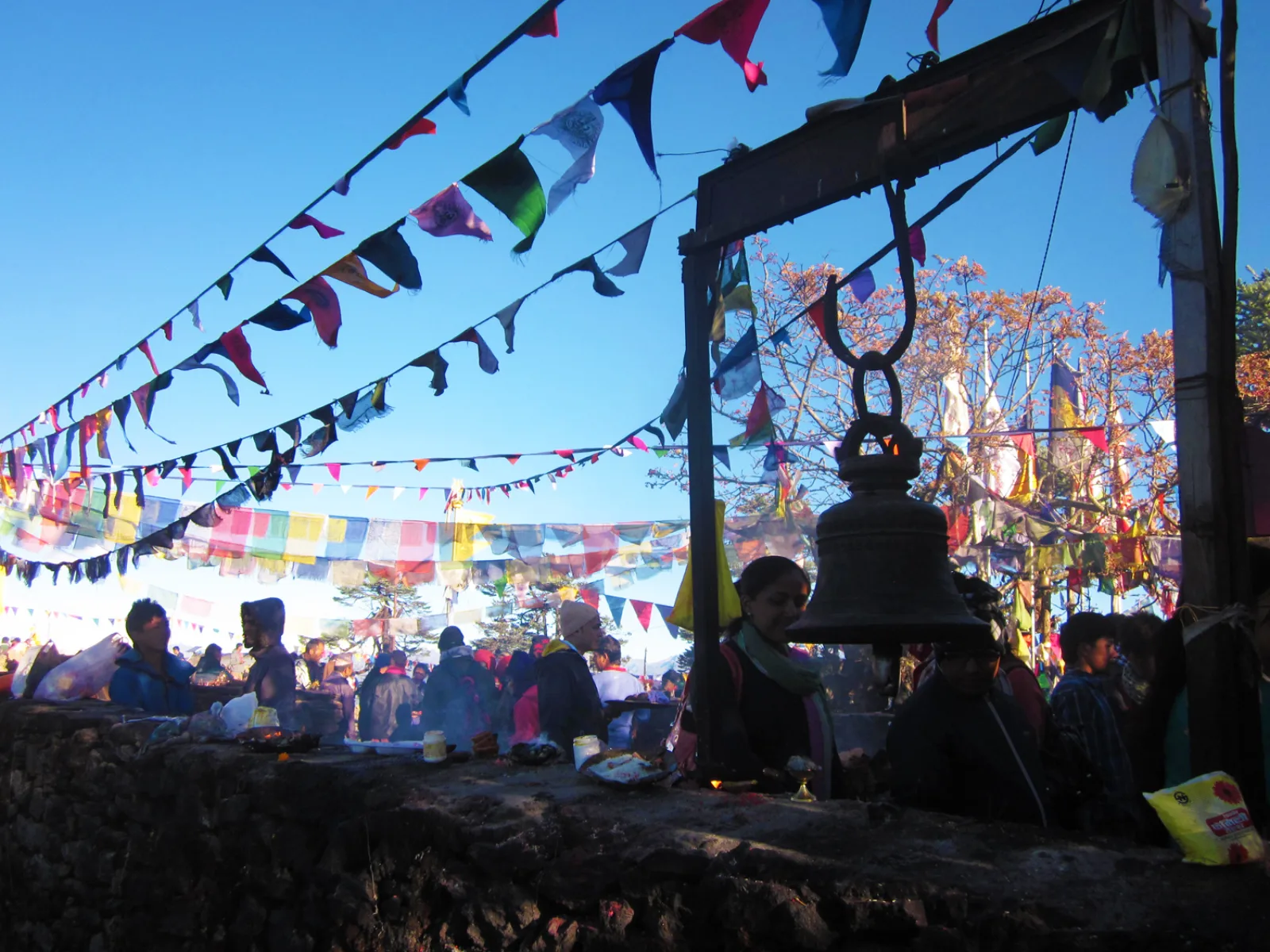 A large bell hangs among prayer flags at Pathibhara Devi Temple.