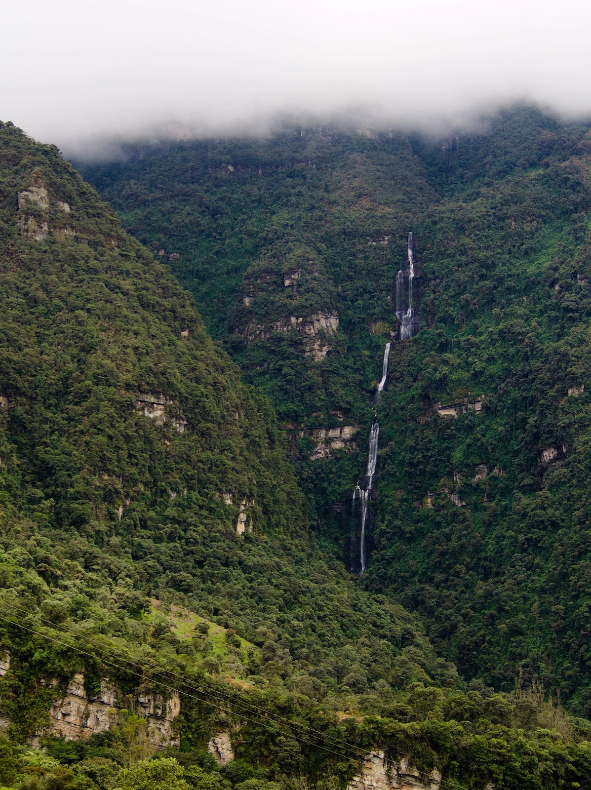 La Chorrera waterfall dropping down a densely forested cliff near Choachí, Colombia.