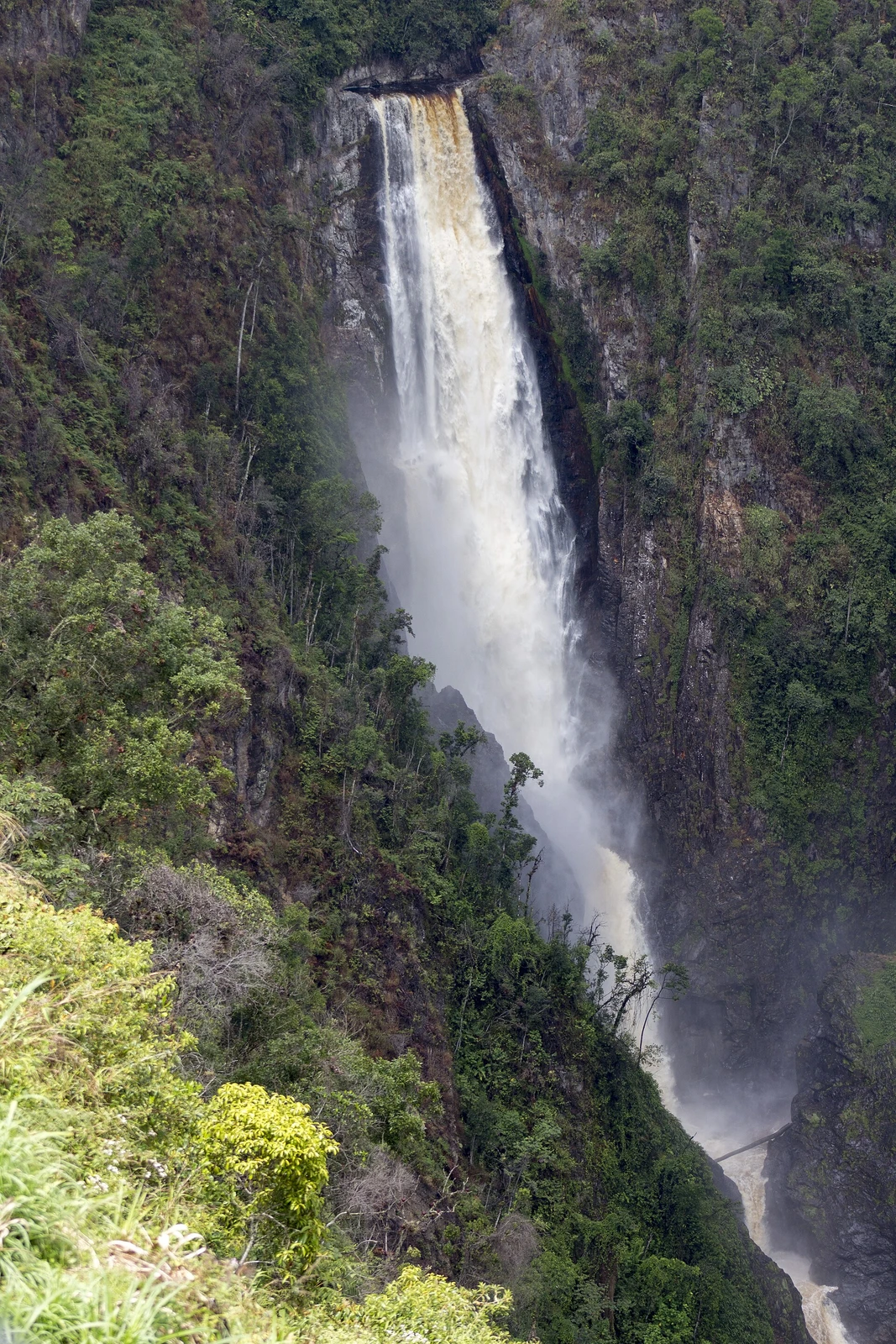 The tall white column of Salto de Bordones dropping between steep green cliffs in Huila, Colombia.